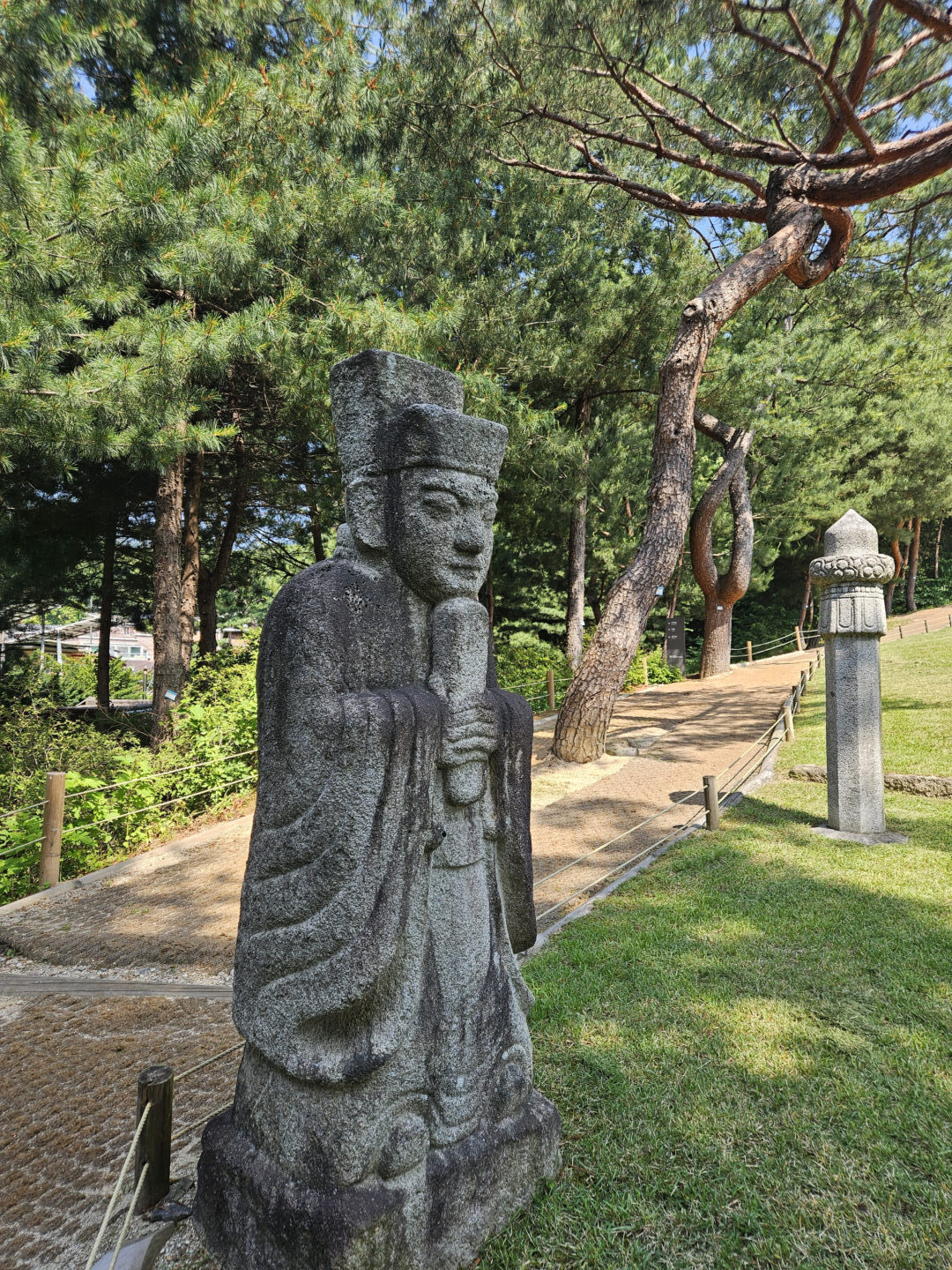 A stone civil official statue (muninsok) standing guard at the tomb of Yeonsan-gun in Seoul